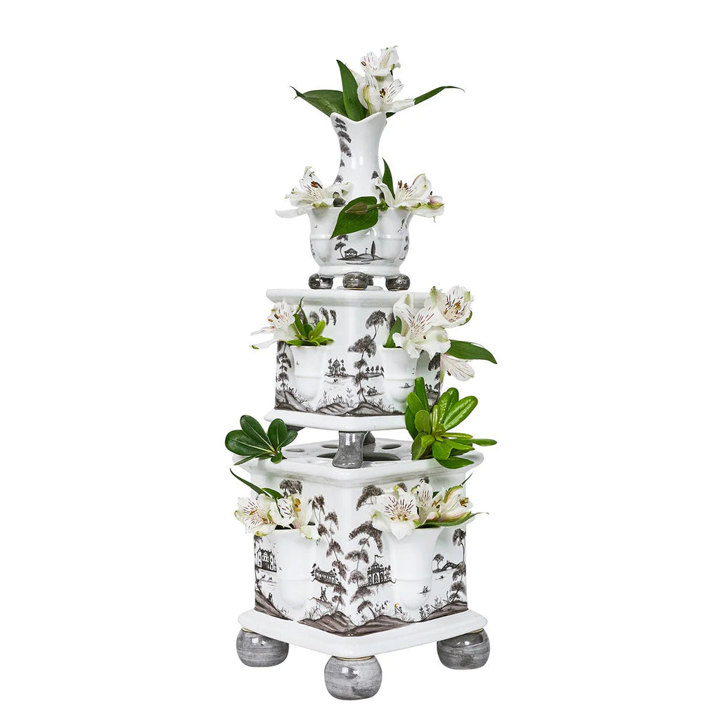 Tulipiere tower set in flint grey, featuring three stacked vases with floral arrangements and intricate landscape designs.