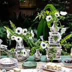 Tulipiere tower set in flint grey, featuring three vases with white flowers and greenery on a table setting.