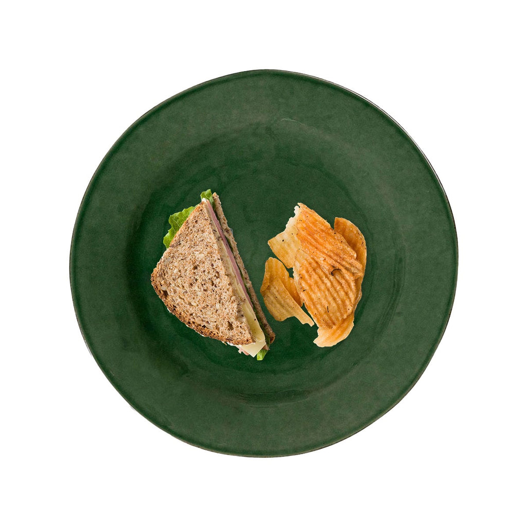 Puro dessert/salad plate in basil color with a sandwich and chips on it, viewed from above.