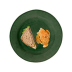 Puro dessert/salad plate in basil color with a sandwich and chips on it, viewed from above.