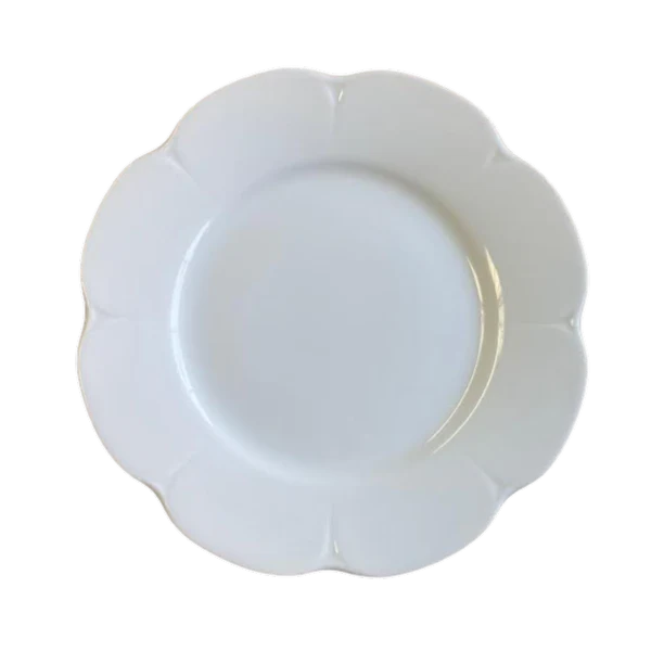 Nymphea white dinner plate with a scalloped edge and smooth surface, viewed from above.