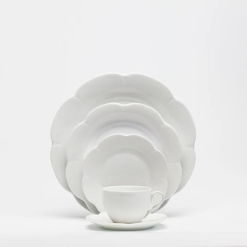 Nymphea white dinner plate set with three plates and a teacup, featuring a scalloped edge design.