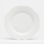 Nymphea white dinner plate with a scalloped edge, featuring a smooth, glossy finish and a round shape.