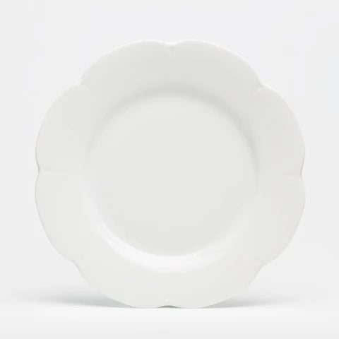 Nymphea white dinner plate with a scalloped edge, featuring a smooth, glossy finish and a round shape.