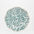 Olivier dinner plate in green with leaf pattern and gold scalloped edge on a white background.