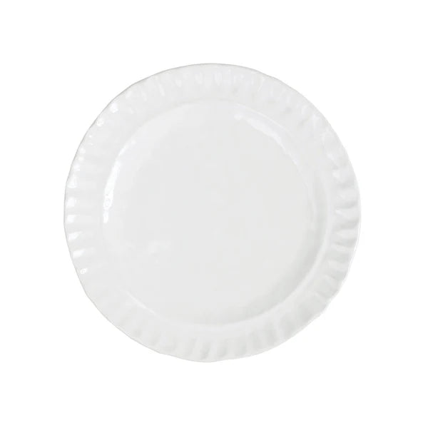 Pietra Serena salad plate in white ceramic with a textured, fluted edge, viewed from above.