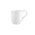 Pietra Serena mug in white ceramic with a textured base and curved handle, positioned at an angle.