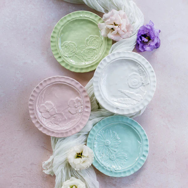 Pietra Fiori white canape plate with floral embossed design, part of a pastel-colored tabletop collection.