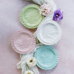 Pietra Fiori white canape plate with floral embossed design, part of a pastel-colored tabletop collection.