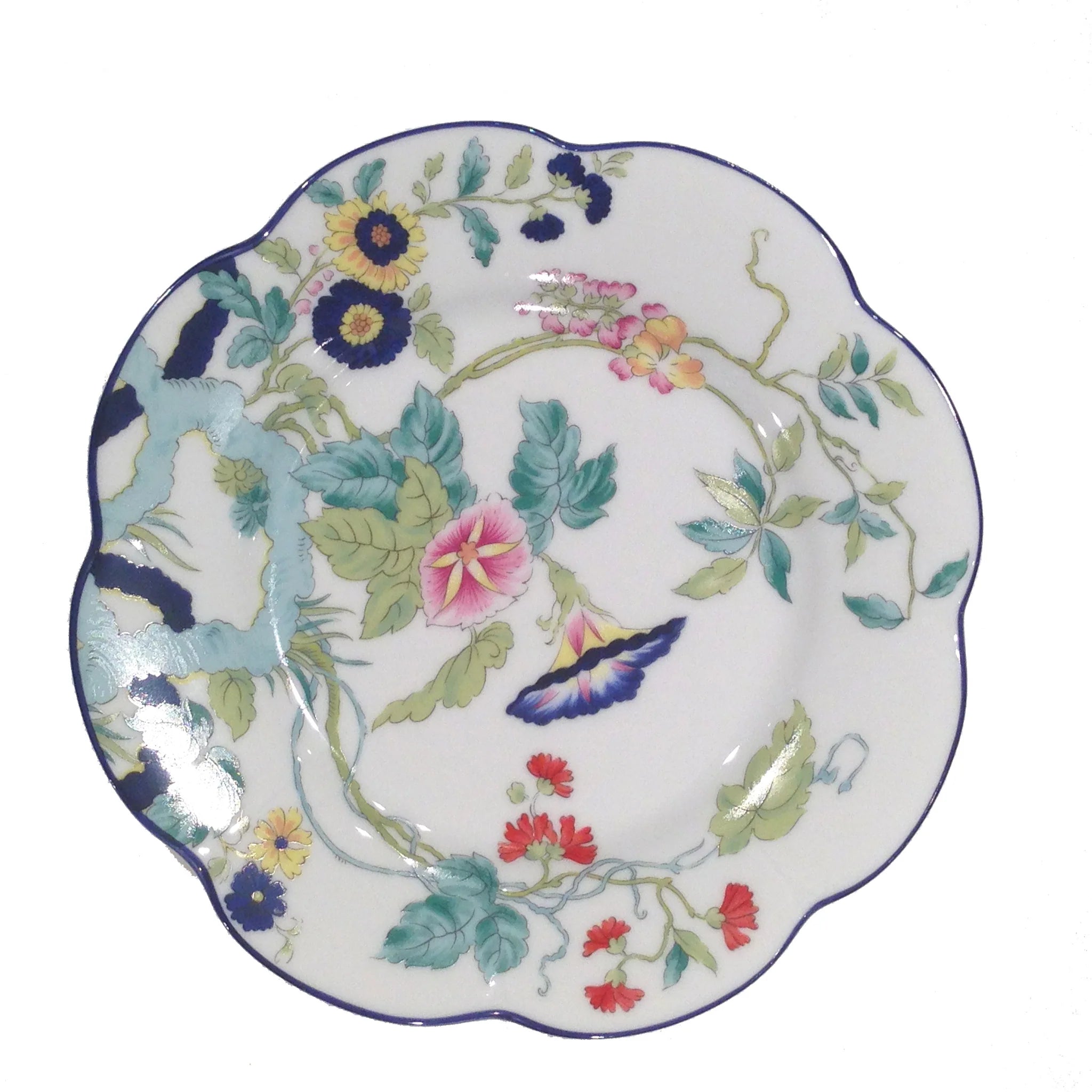 Paradis Bleu dinner plate featuring a floral design with vibrant colors and a scalloped edge.