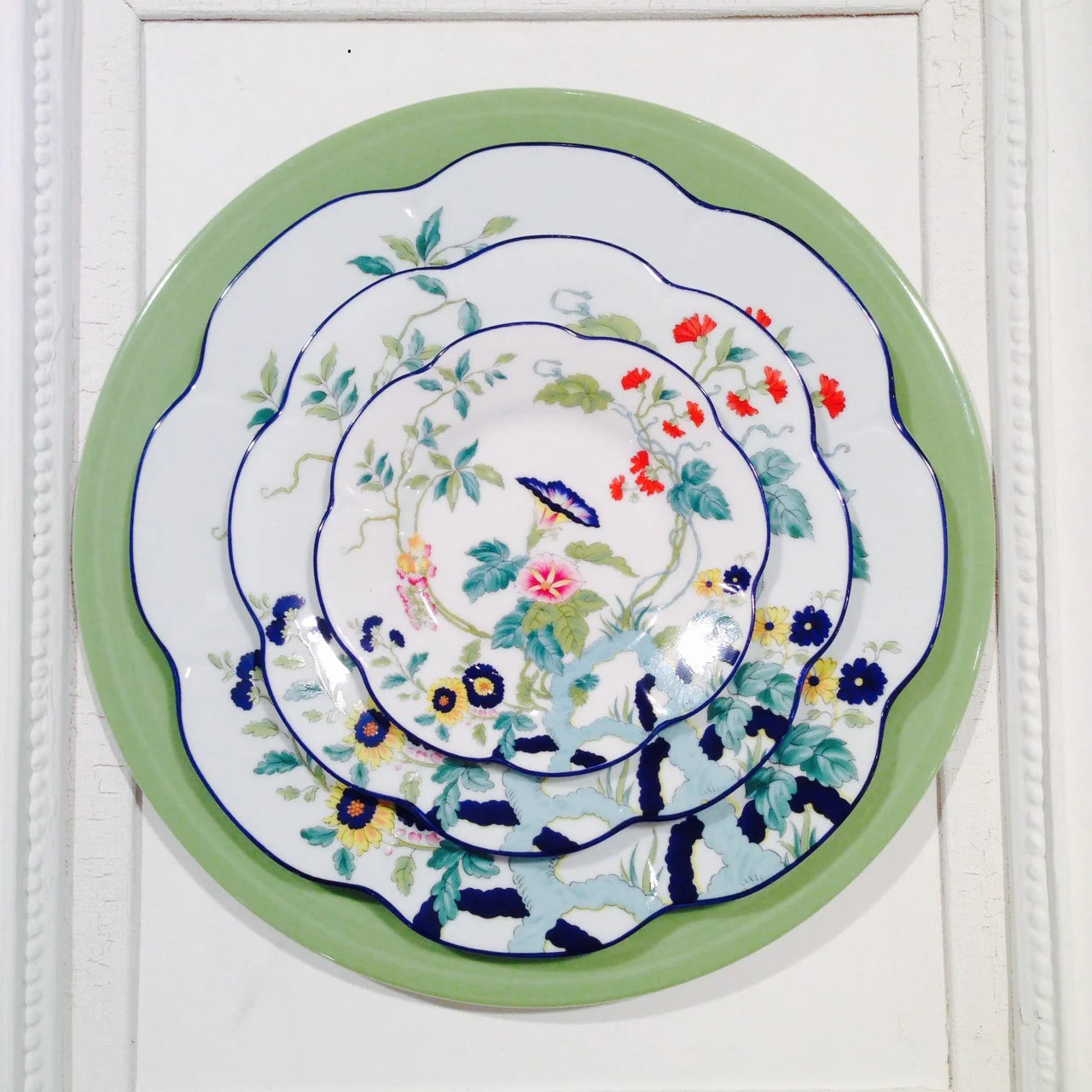 Paradis Bleu bread and butter plate featuring floral designs in blue, pink, and green on a white background.