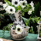 Country Estate tulipiere vase in flint grey with white anemone flowers and green foliage, featuring intricate landscape de...