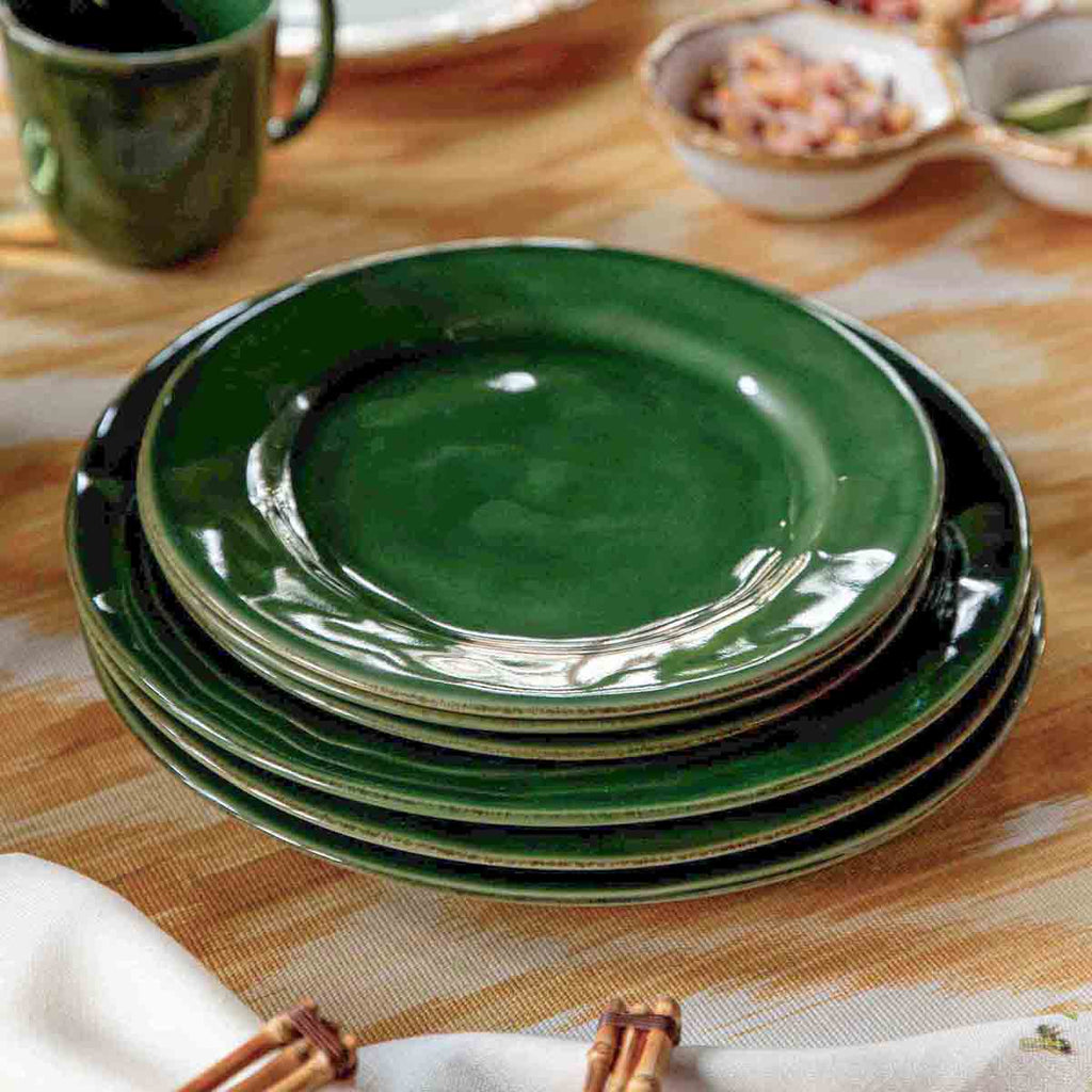 Puro dessert/salad plate in basil green, featuring a glossy finish and a smooth, round design, stacked on a table.