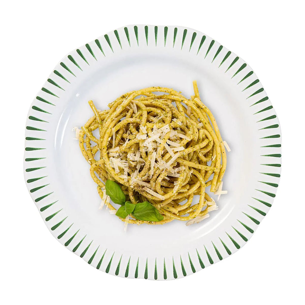 Sitio stripe dinner plate in basil color featuring pasta topped with cheese and fresh basil leaves.