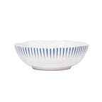 Sitio stripe coupe bowl in Delft blue with white base and blue vertical stripes, showcasing a scalloped edge.
